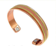 A copper bangle with two healing magnets